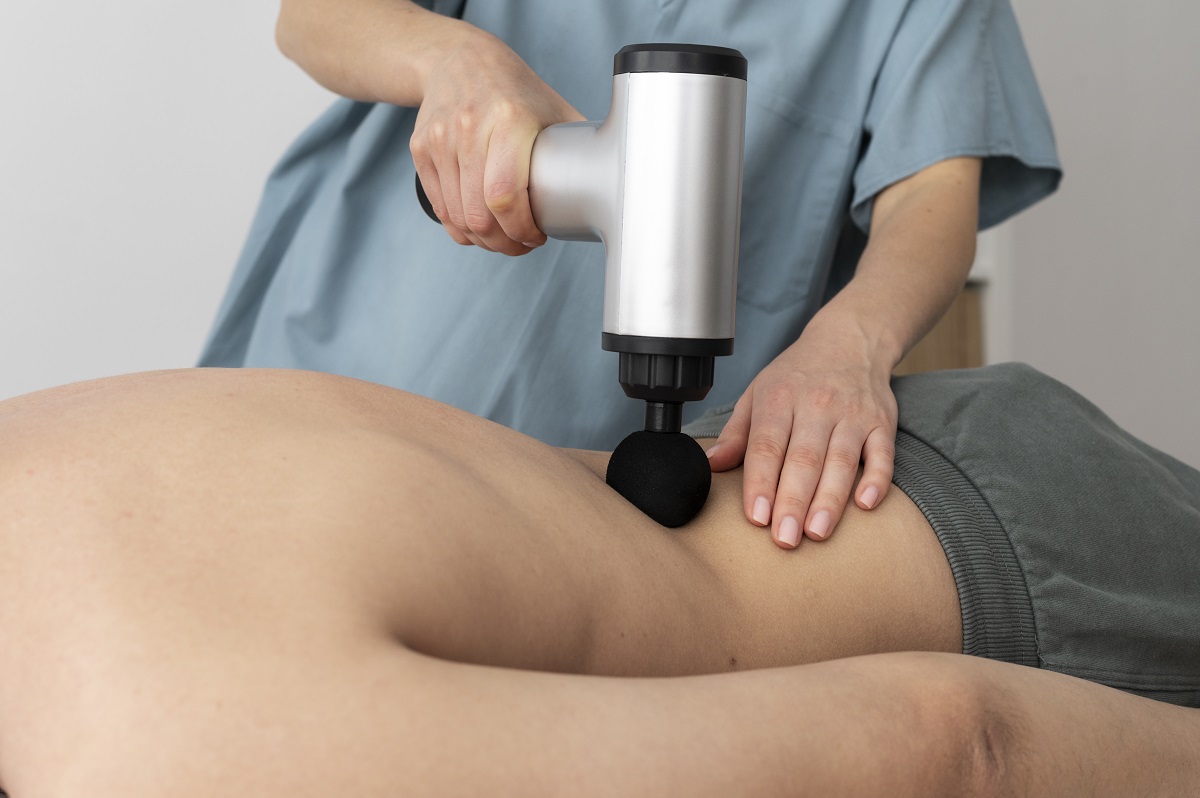 person-using-massage-gun